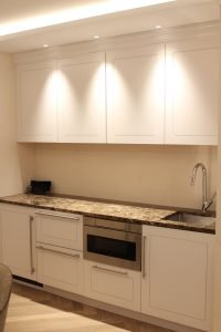 Integrated appliances and thoughtful layout transformed a blank space with three walls into an efficient and beautiful work area.