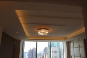 The goal for this ceiling was to create varying planes from which light could escape. The main light fixture draws attention back to center.