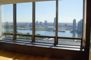 Custom milled wood flooring was installed in this project and butts up to Trespa-clad radiator covers. These details send your eye wandering to the fabulous view.