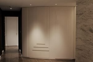 Custom curved doors conceal storage and elicit thoughts of eras gone by.