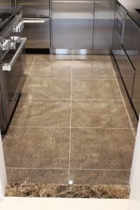 A large tile was used in order to keep grout lines to a minimum and allow attention to be paid to the gleaming stainless steel installations.