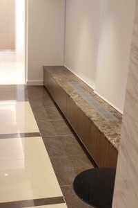 Imported Spanish marble tops are continued throughout, placed on top of a custom-built HVAC cover.