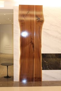 Custom wood cladding adds drama to the living room's stone centerpiece