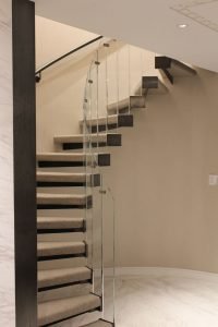 Defy gravity when using this floating staircase. The curves were wrapped in clear glass to confirm to all in attendance that the user is truly suspended in the air.