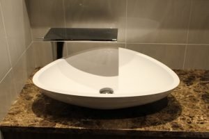 When a rectangle sink is too, well, square for a bathroom, a more well-rounded replacement works out beautifully.